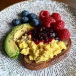 Colorful Breakfast Plate with Scrambled Eggs, Avocado, PB&J Toast & Fresh Berries